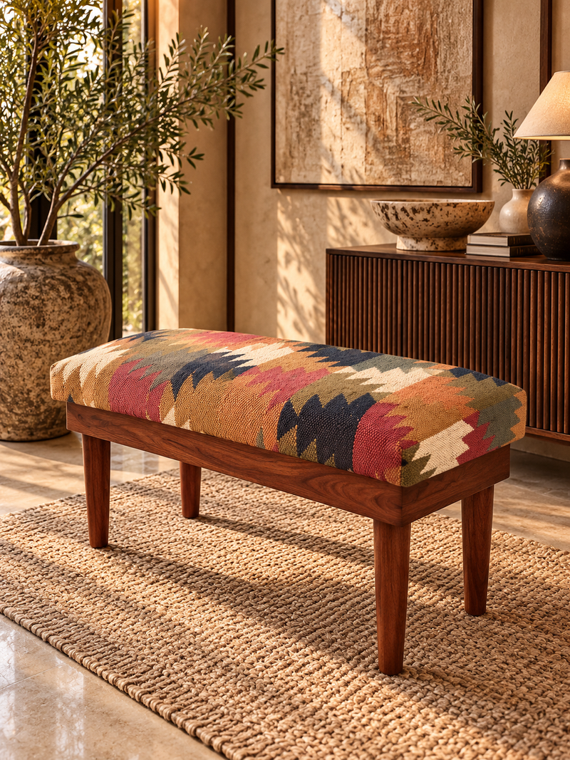 Almora Kilim Bench in handwoven vintage kilim on tapered solid wood legs, angled in front of a fluted sideboard — Art Avenue, made to order