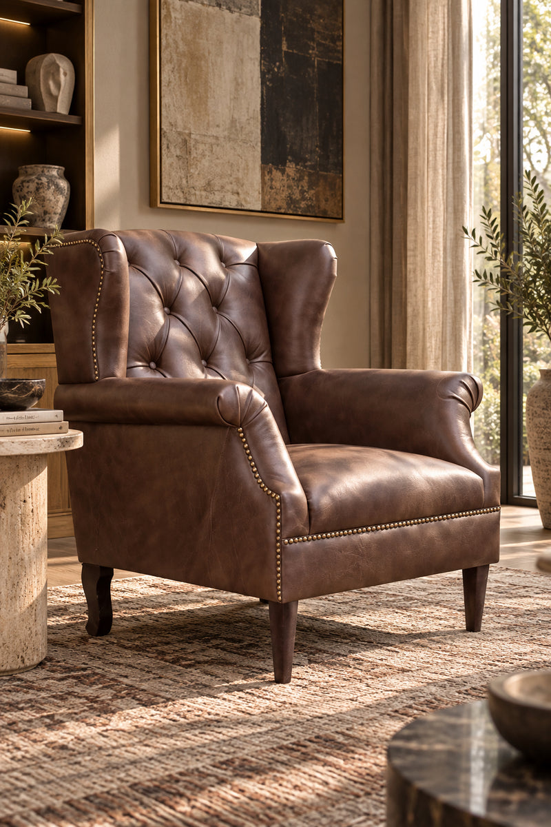 Kasauli studded leather wing chair in Hazel upholstery leather with walnut legs, three-quarter view, Art Avenue made-to-order seating