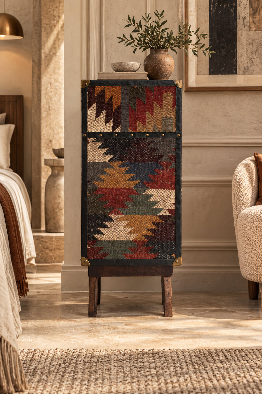 Full-height vintage kilim flank with studded leather banding and brass corner caps on the Sardargarh sideboard, Art Avenue made-to-order storage