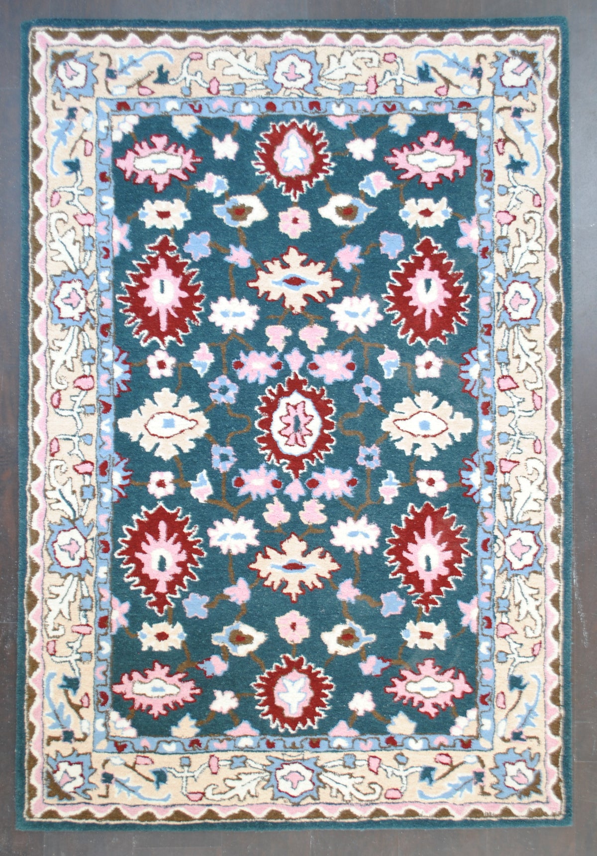 Srinagar hand-tufted rug in 100% New Zealand wool, full overhead view: crimson rosettes and ivory palmettes on a deep teal field with a cream vine border, Art Avenue, 4×6 ft