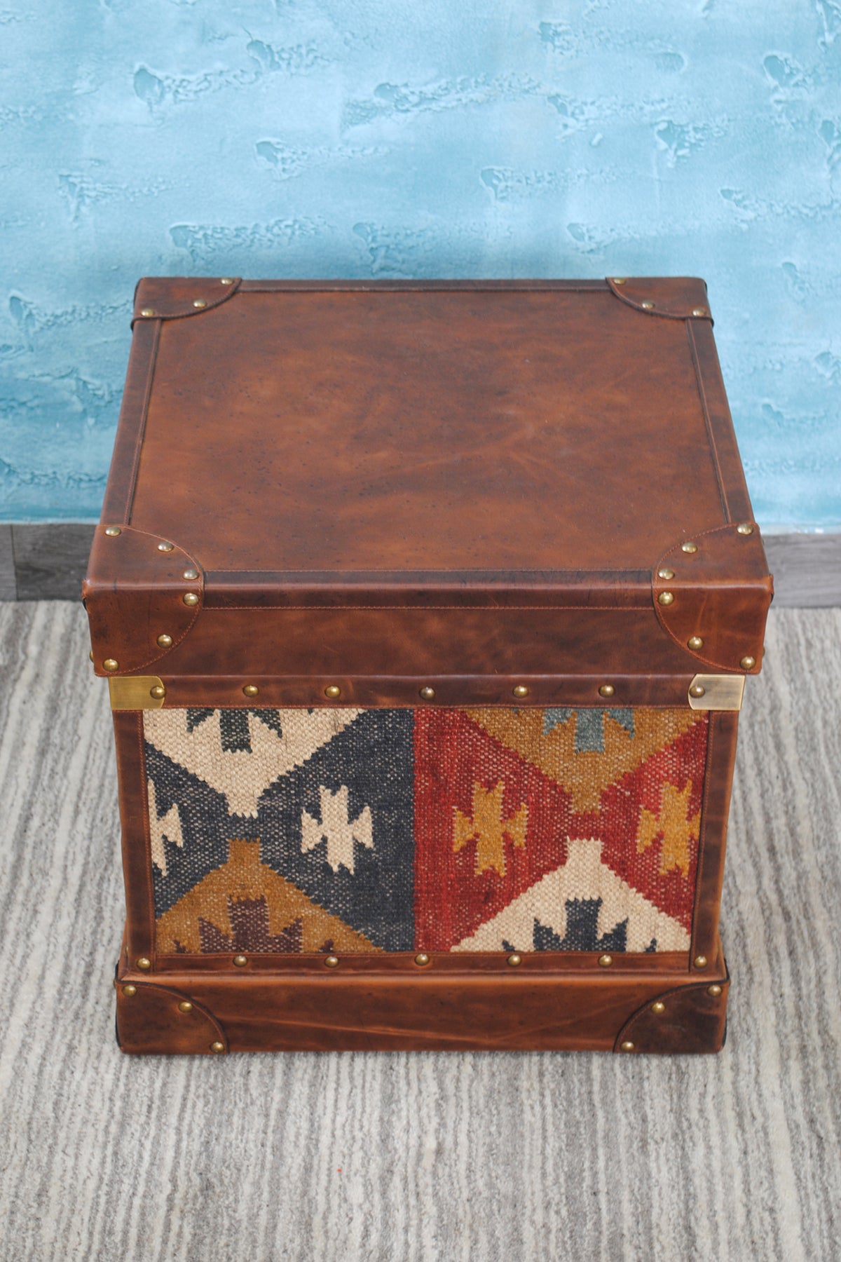 Overhead view of the Madras trunk showing the full leather lid, a flat surface for a lamp