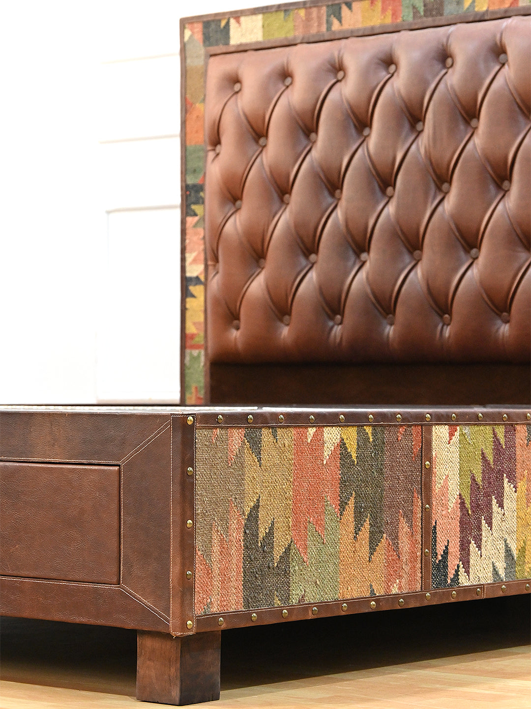 Narlai kilim and leather storage bed by Art Avenue, made to order — buttoned leather headboard beside the kilim side panel