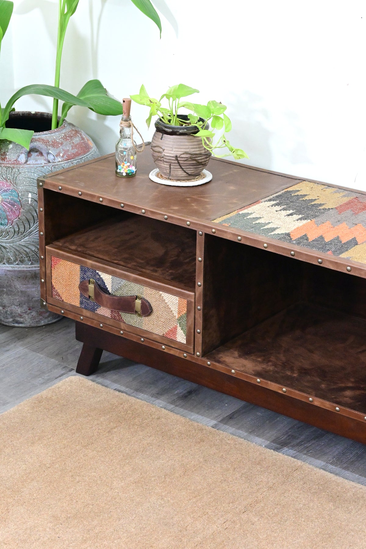 Left end of the Ranakpur TV unit, kilim drawer with leather strap handle and the suede-lined open bay