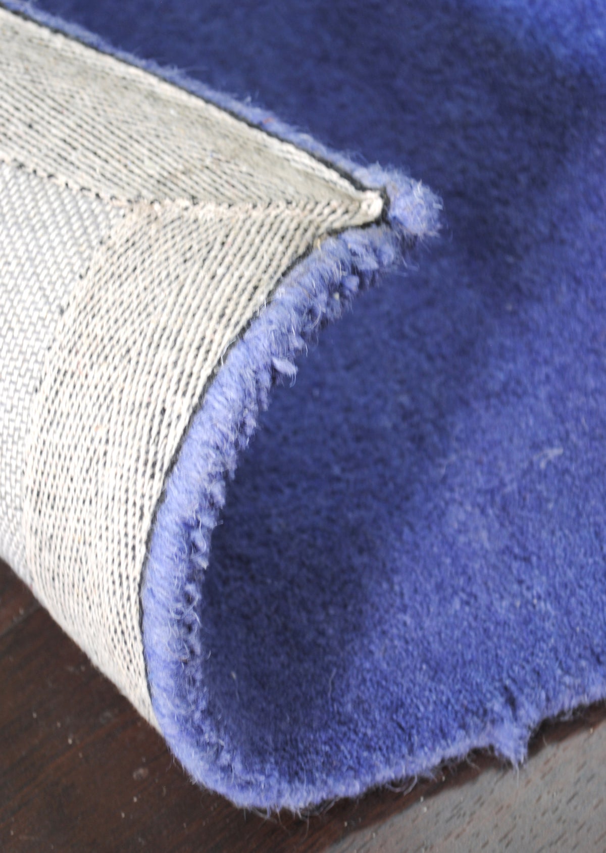 Underside of the Mahe rug: cotton canvas backing and wool-bound edge