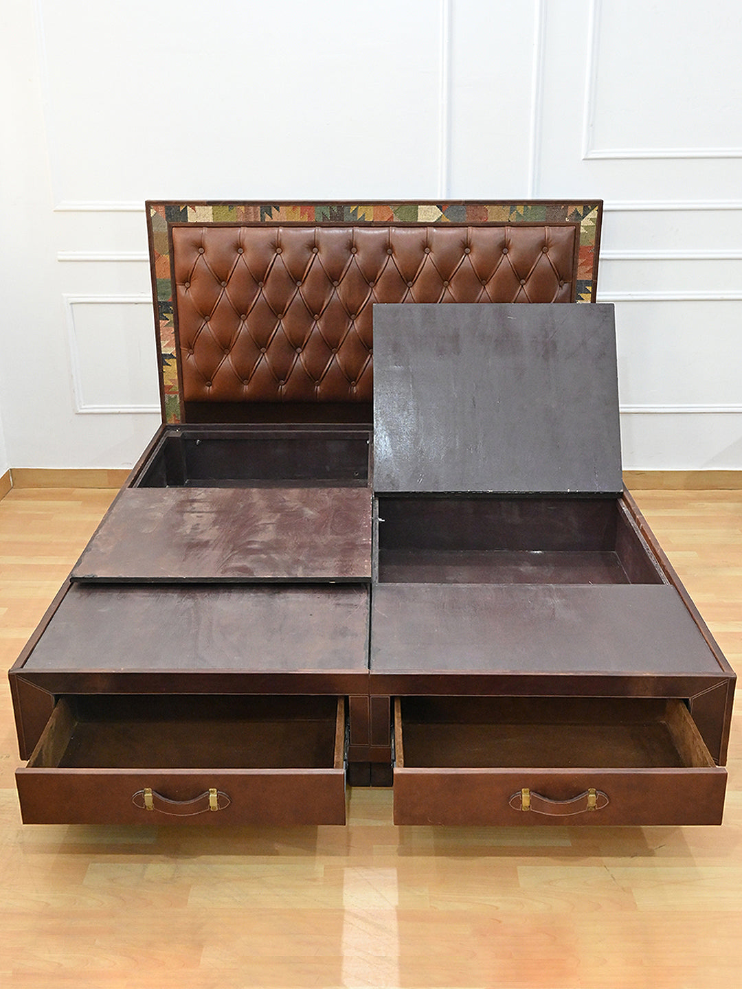 Narlai kilim and leather storage bed by Art Avenue, made to order — overhead view with platform panels lifted and drawers open