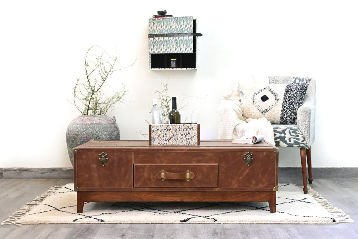 Kuchaman leather trunk coffee table in a styled living room, wide view — Art Avenue, made to order