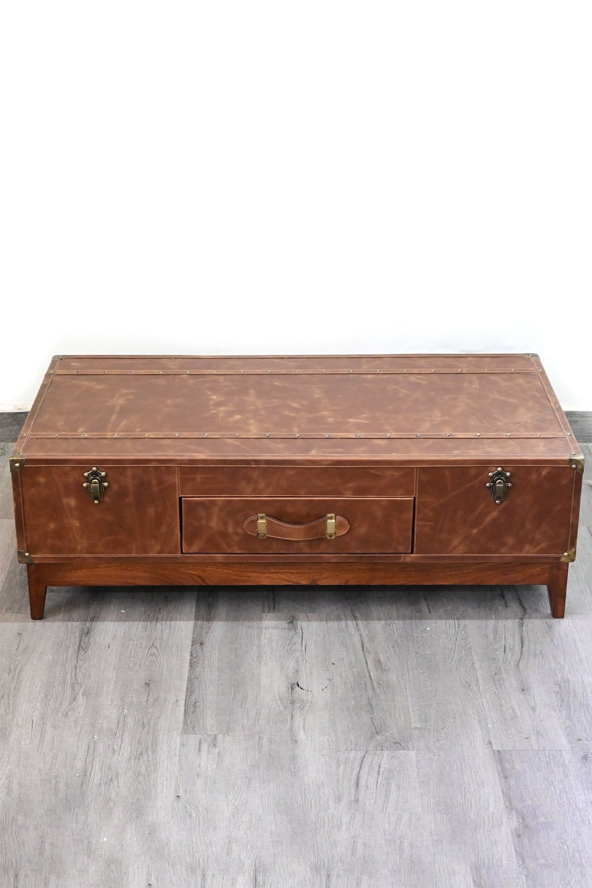 Kuchaman leather trunk coffee table from above: three-panel leather top with full-length studded straps