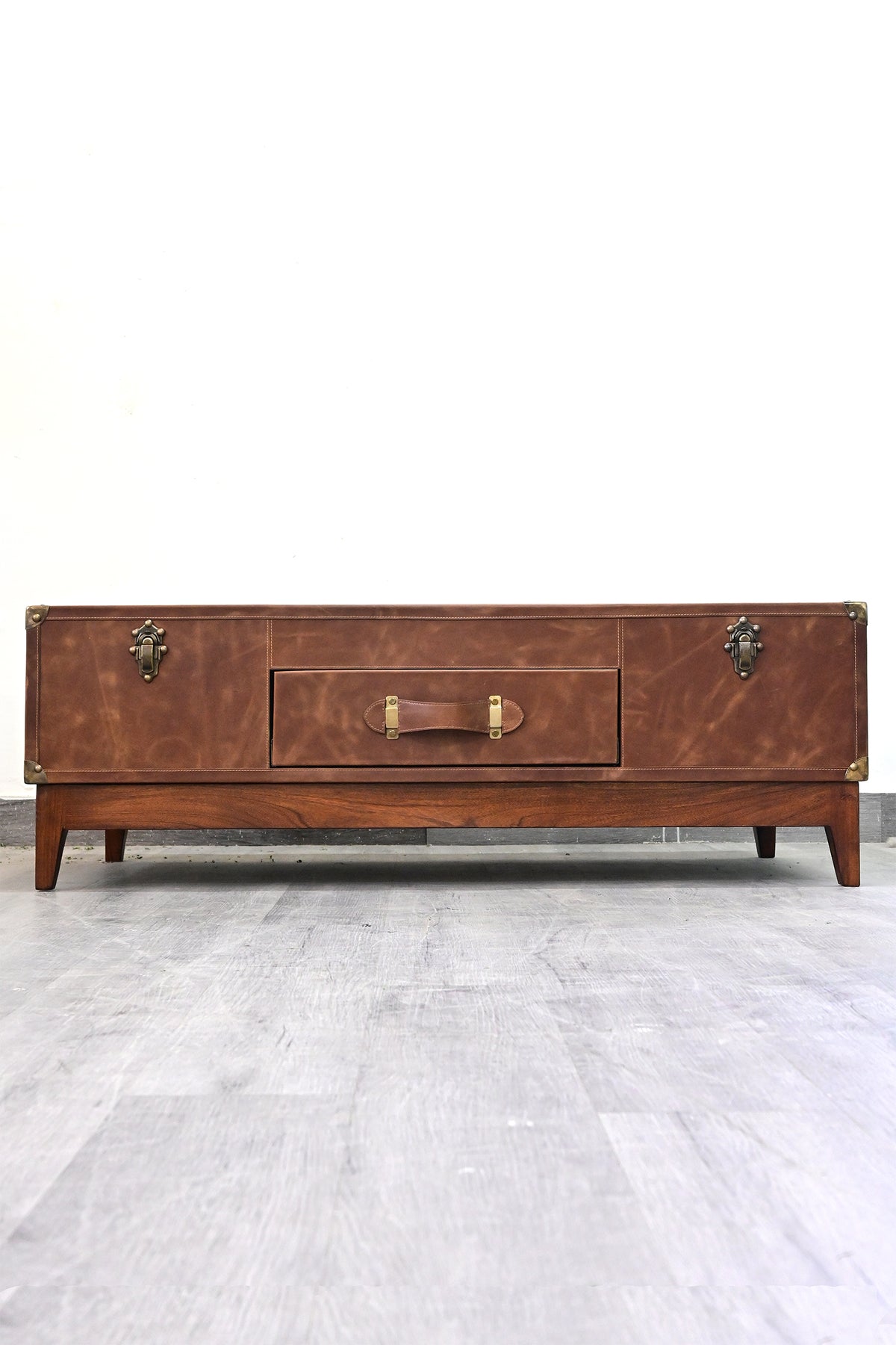 Kuchaman leather trunk coffee table, front view: centre drawer with leather strap handle between two trunk catches