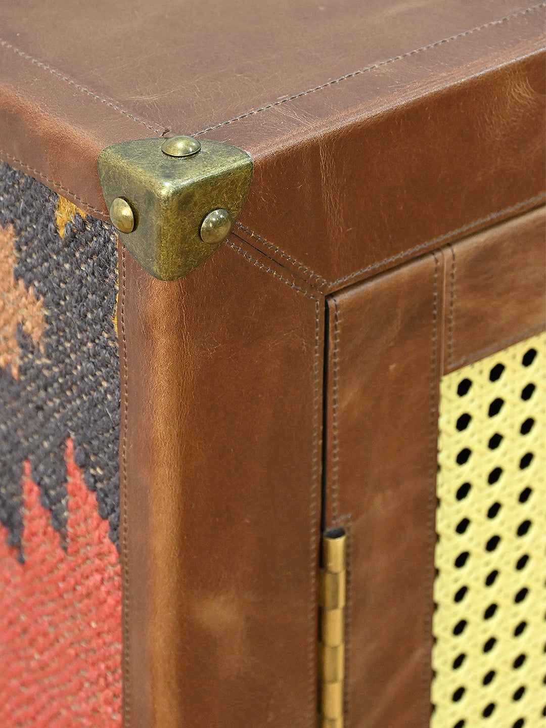 Brass corner cap at the junction of leather and vintage kilim, Fatehpur sideboard, Art Avenue