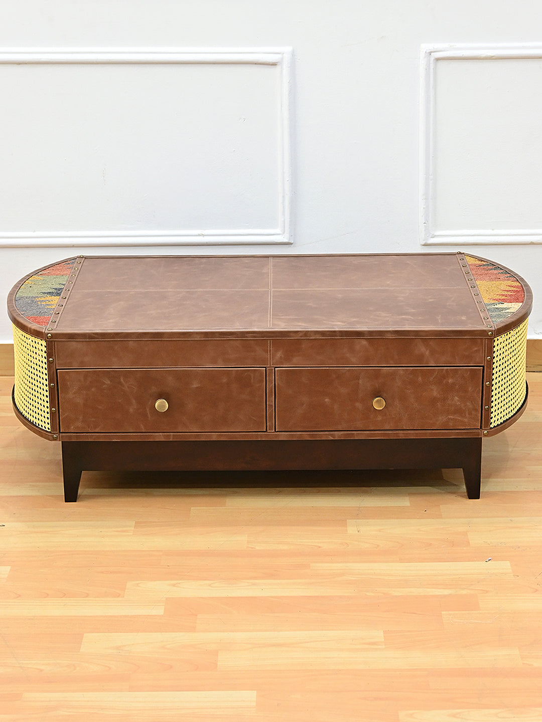 Raised front view of the Bisalpur coffee table showing the kilim half-moons set into the leather top