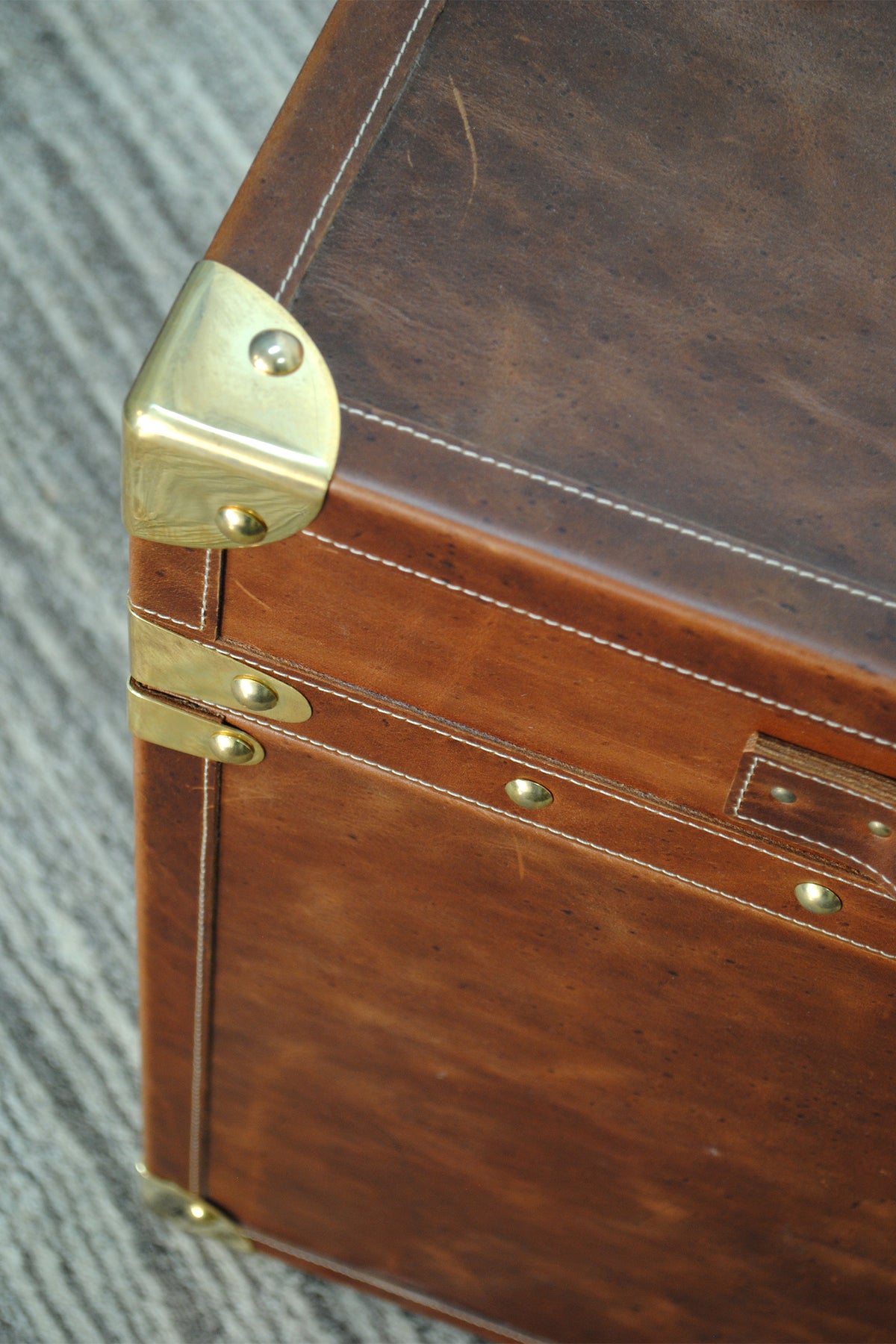 Brass corner and lid-seam bracket detail on the Cordoba Leather Cube Trunk