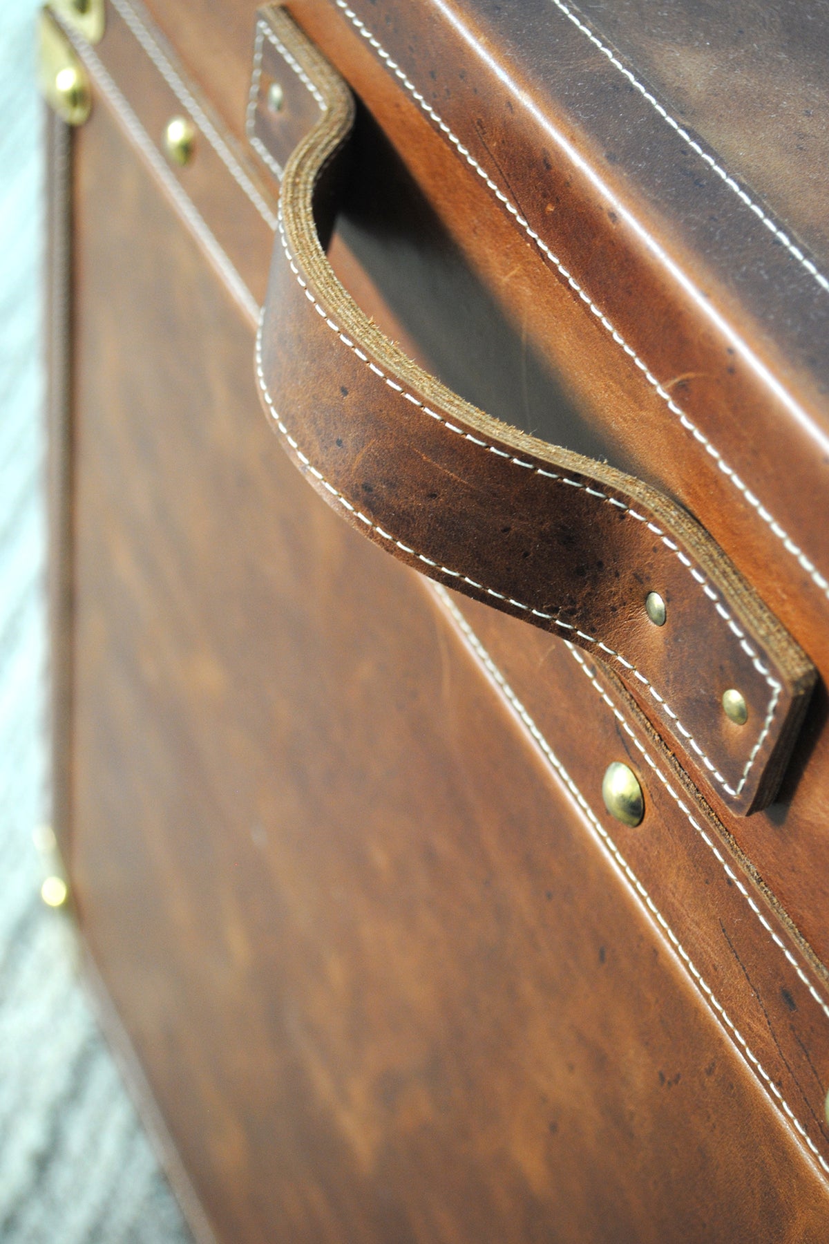 Stitched leather carry handle on the lid of the Cordoba Leather Cube Trunk