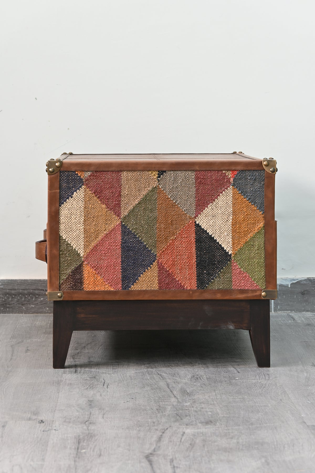 Close view of the diamond-weave vintage kilim panel on the flank of the Barmer TV unit
