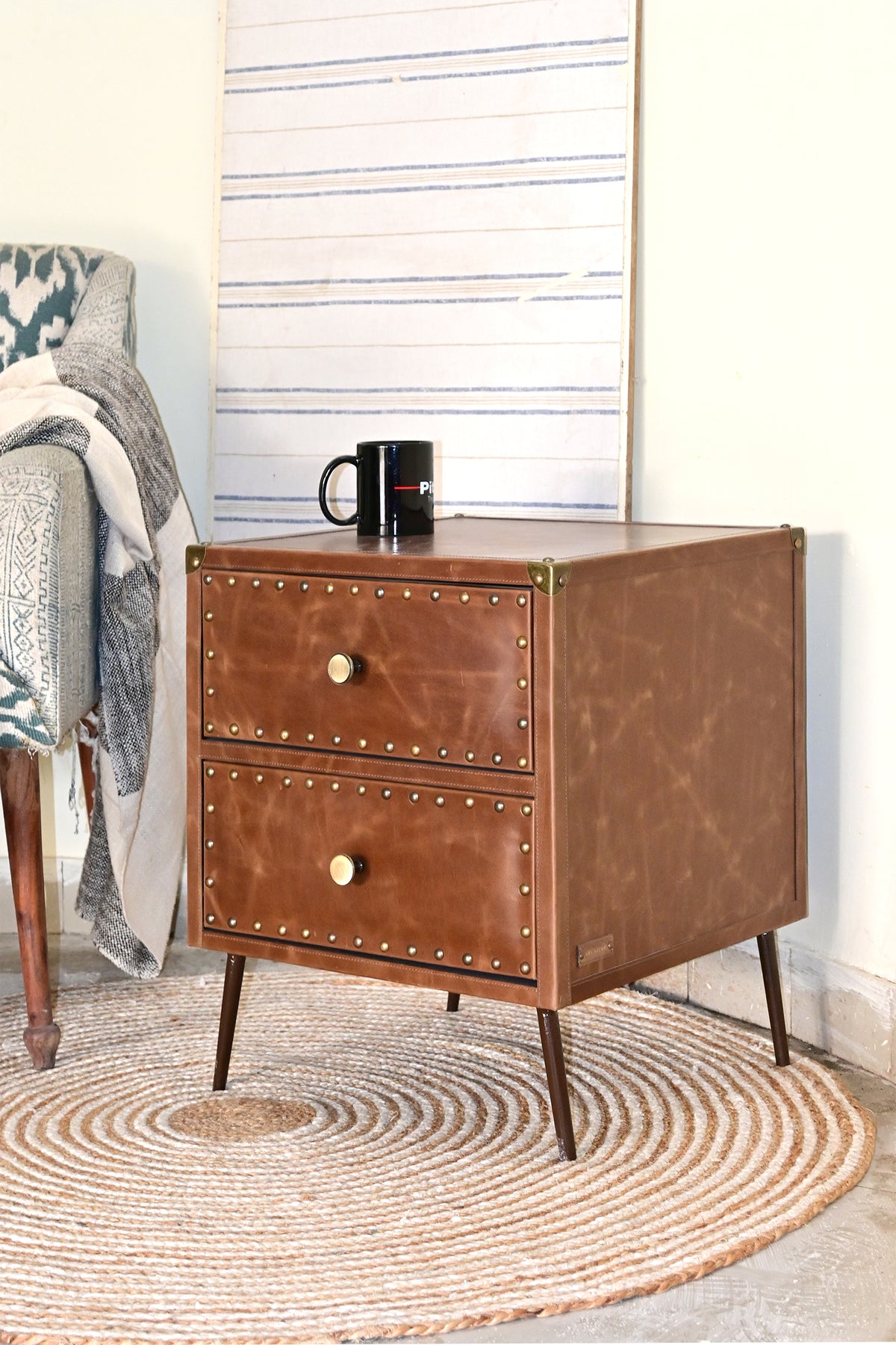 Kishangarh leather bedside table in a bedroom corner, three-quarter view, tapered metal legs, Art Avenue