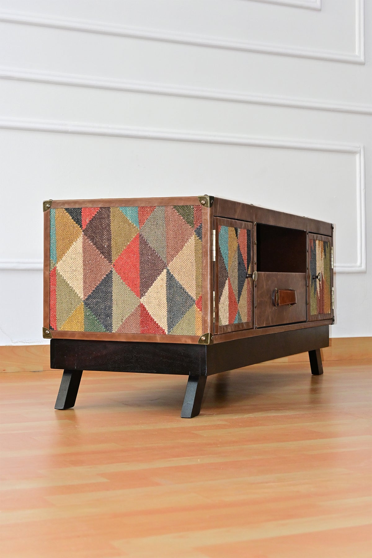 Side view of the Karauli TV unit showing the full-height kilim flank panel