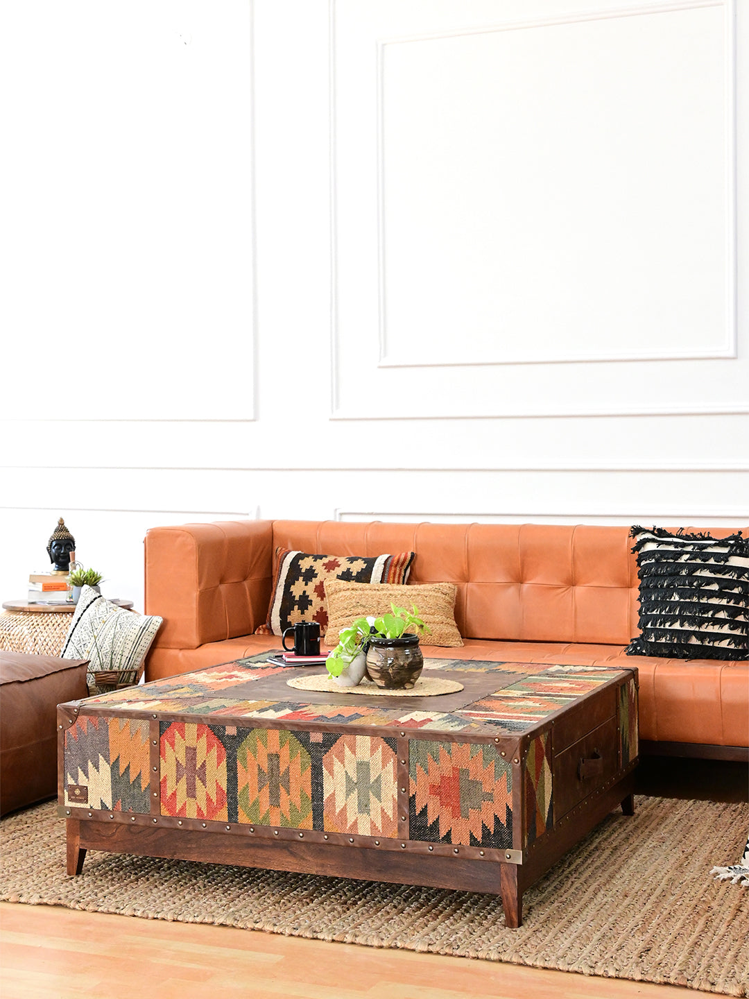 Mandawa kilim trunk coffee table centred on a jute rug before a leather sofa, 120 cm square, Art Avenue