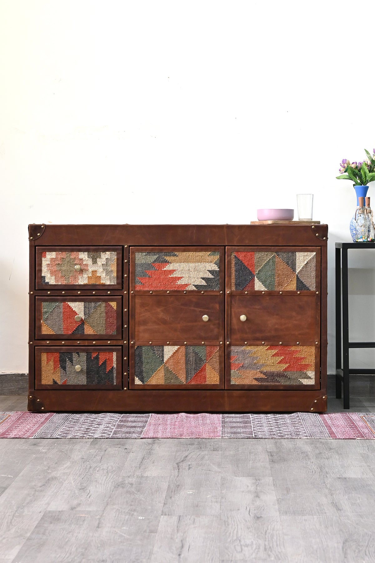 Nimaj Kilim & Leather Sideboard styled against a white wall on a block-print runner — Art Avenue, made to order