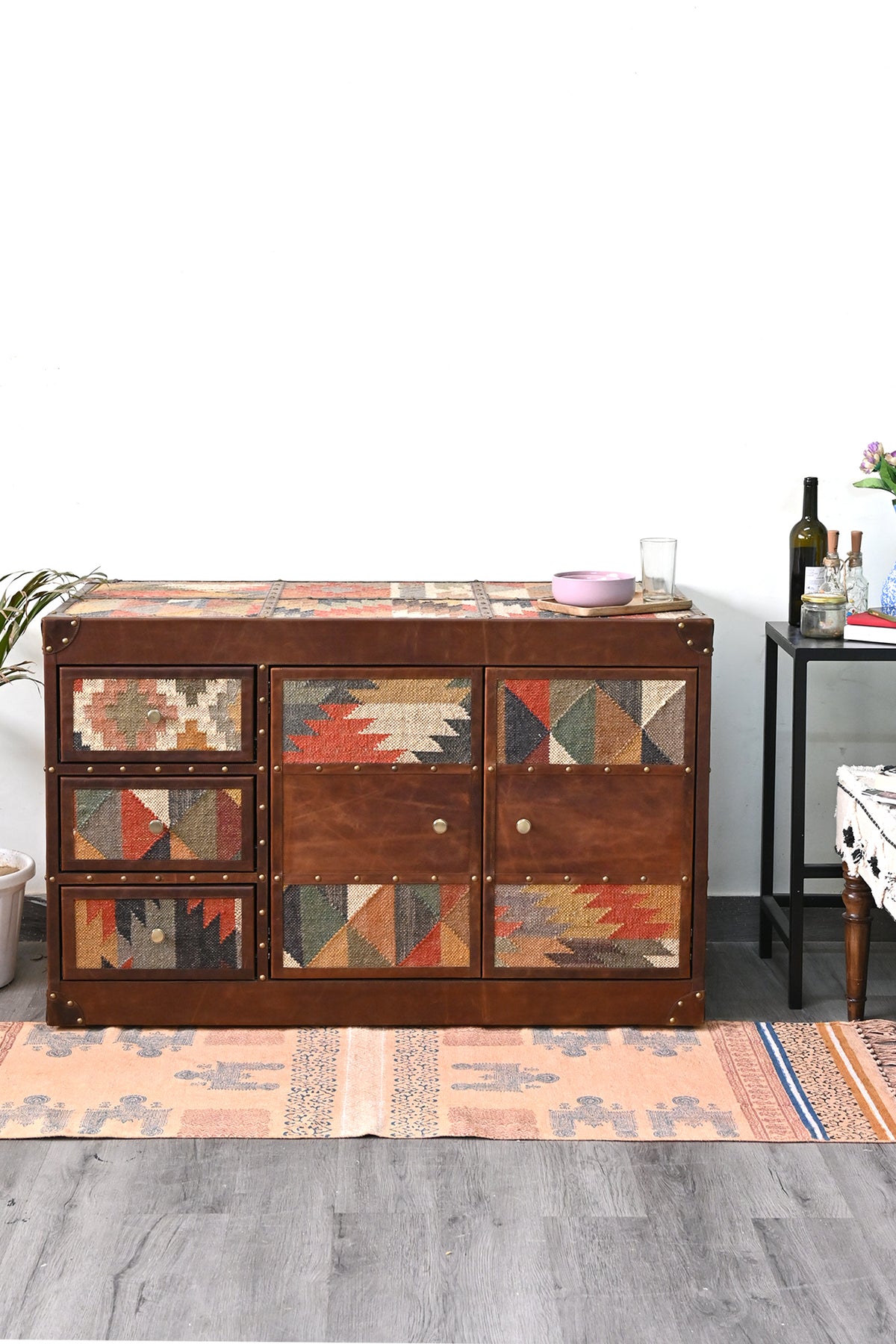 Nimaj Kilim & Leather Sideboard styled in a living room, kilim top and brass-studded leather front — Art Avenue, made to order