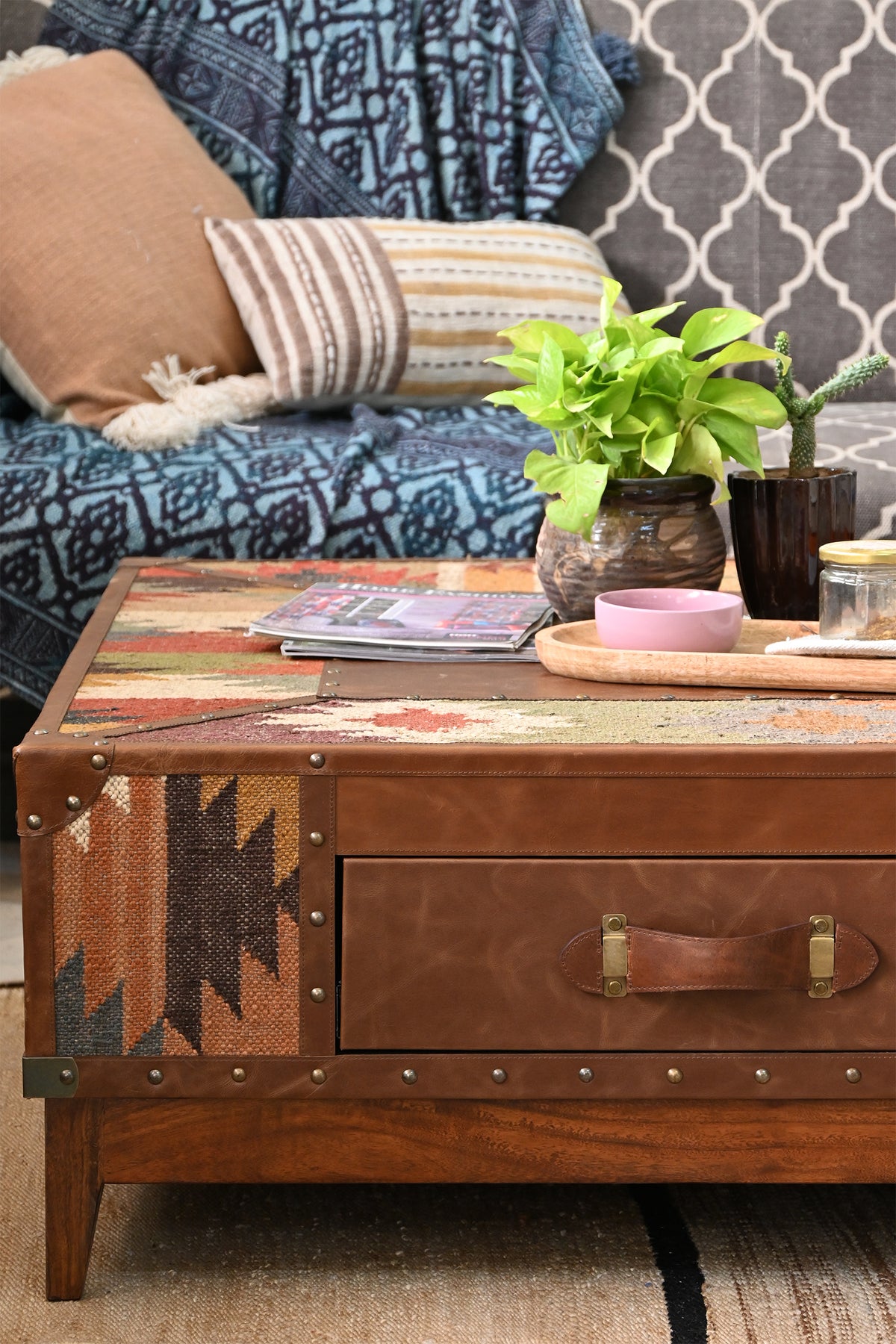 Close view of the leather-fronted drawer and studded kilim side of the Mandawa coffee table