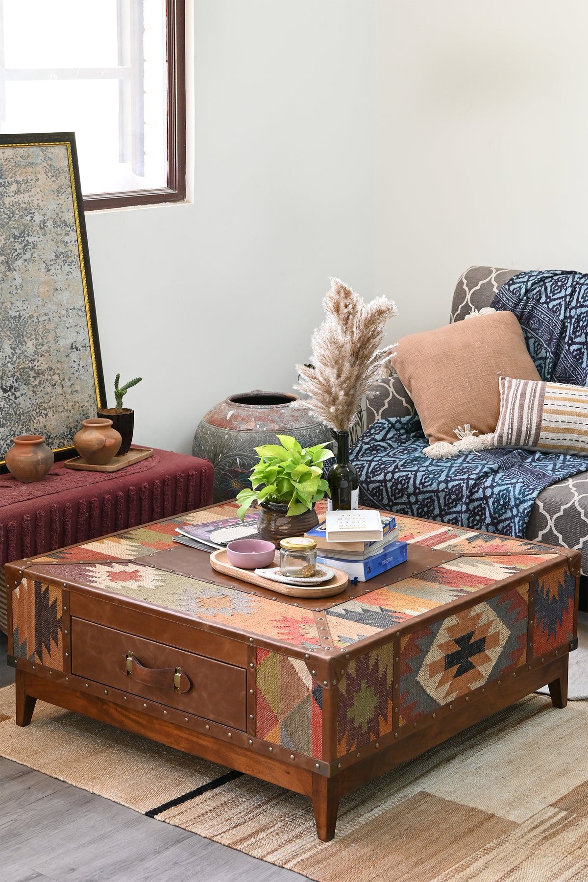 Square Mandawa kilim trunk coffee table centred on a jute rug in a boho living room