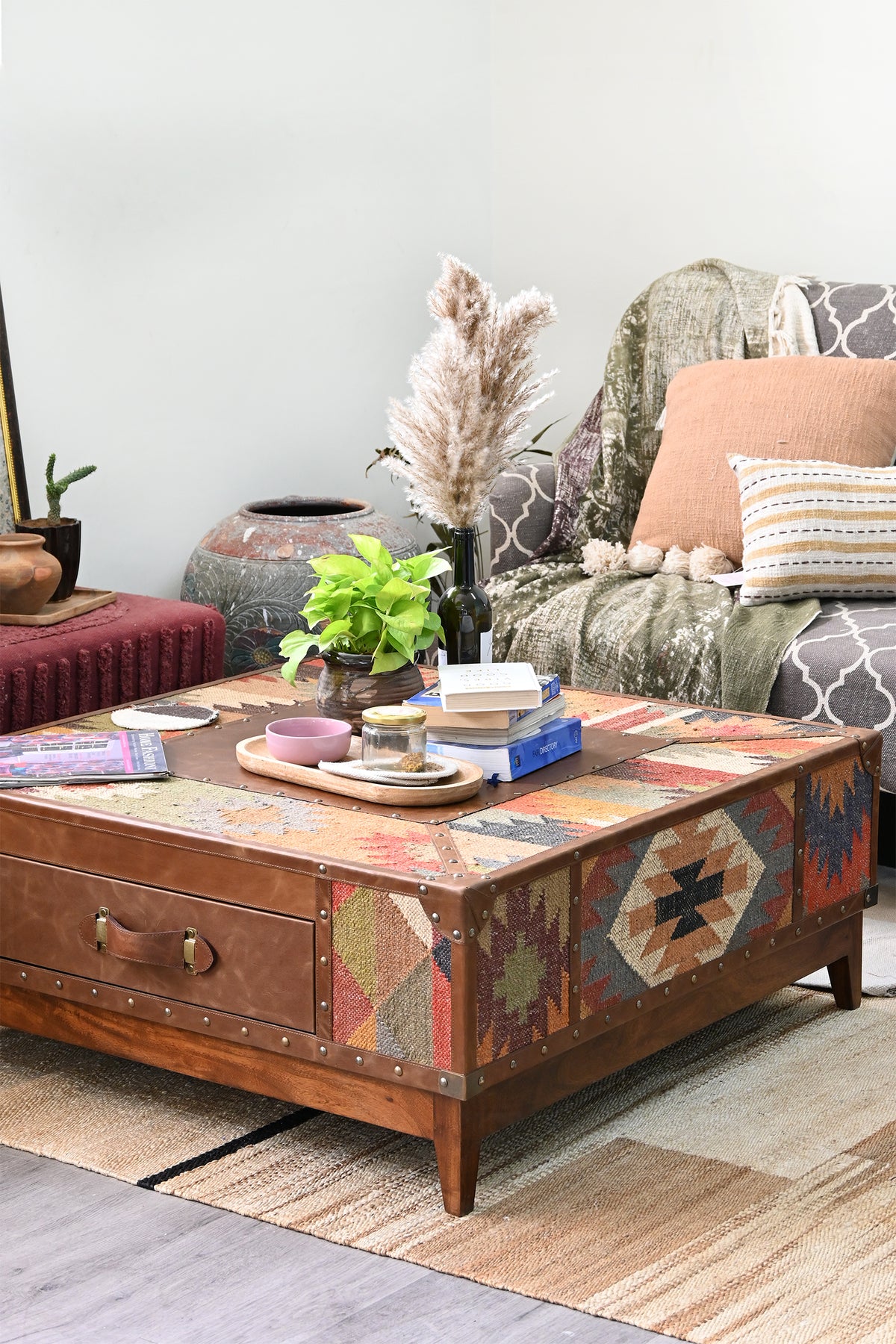 Mandawa kilim and leather trunk coffee table beside a sofa, angled from the right