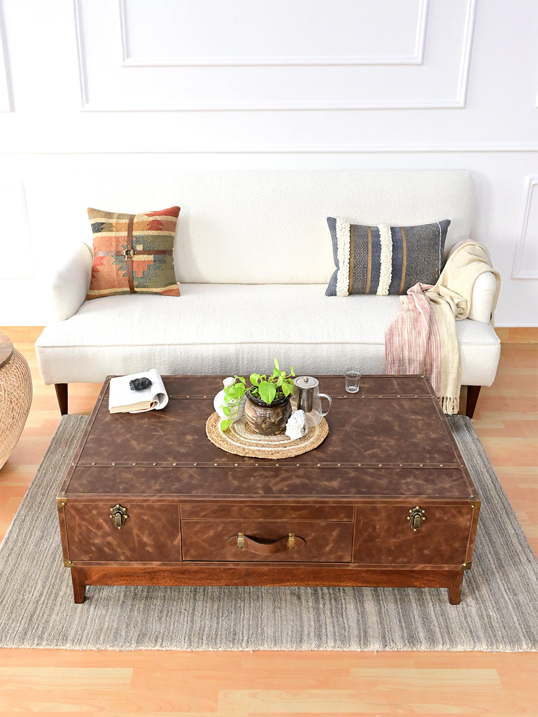 Nawalgarh leather trunk coffee table from above at an angle, showing the three-panel leather top with studded straps
