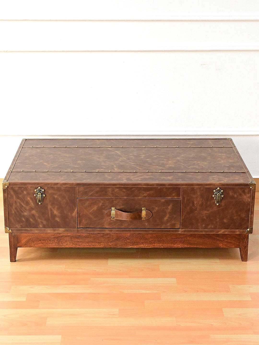 Nawalgarh leather trunk coffee table, raised front view showing the studded top straps
