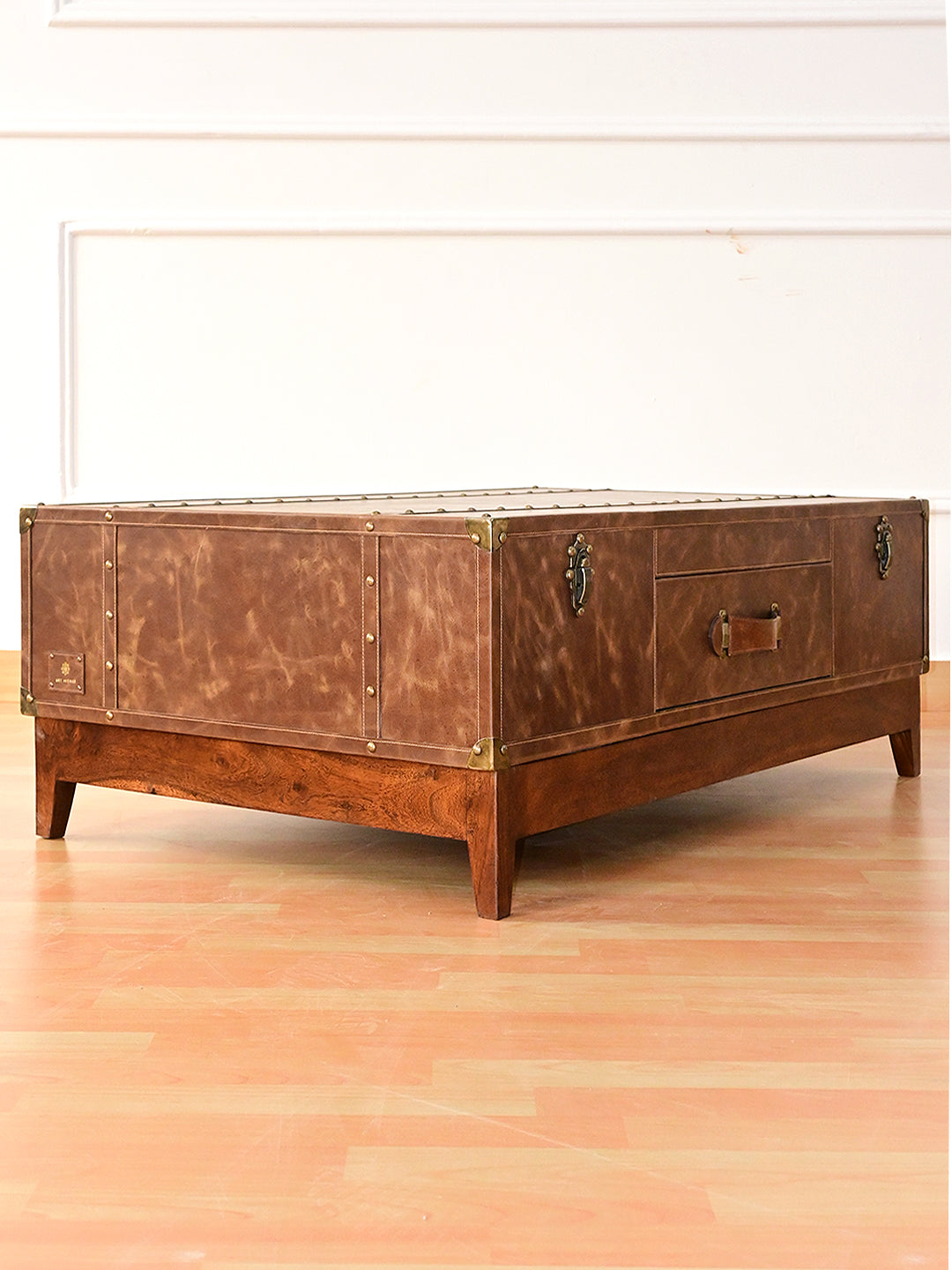 Nawalgarh leather trunk coffee table, three-quarter view of the end panel and tapered solid wood legs