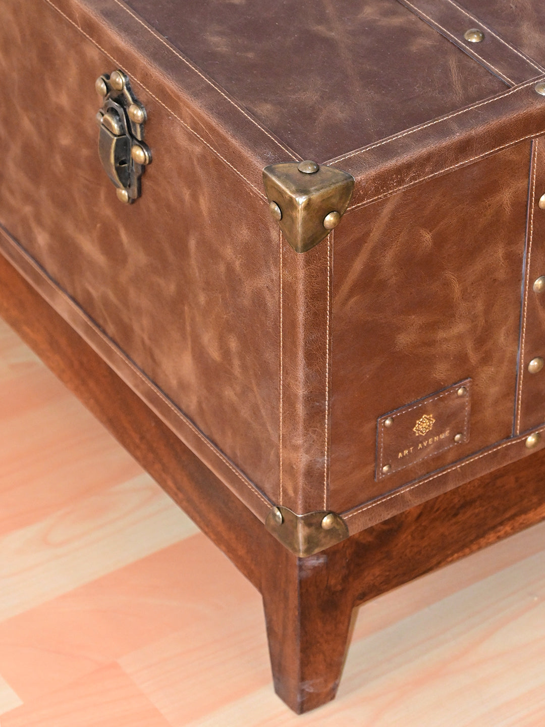 Nawalgarh leather trunk coffee table, close-up of the top corner cap and trunk catch on distressed leather