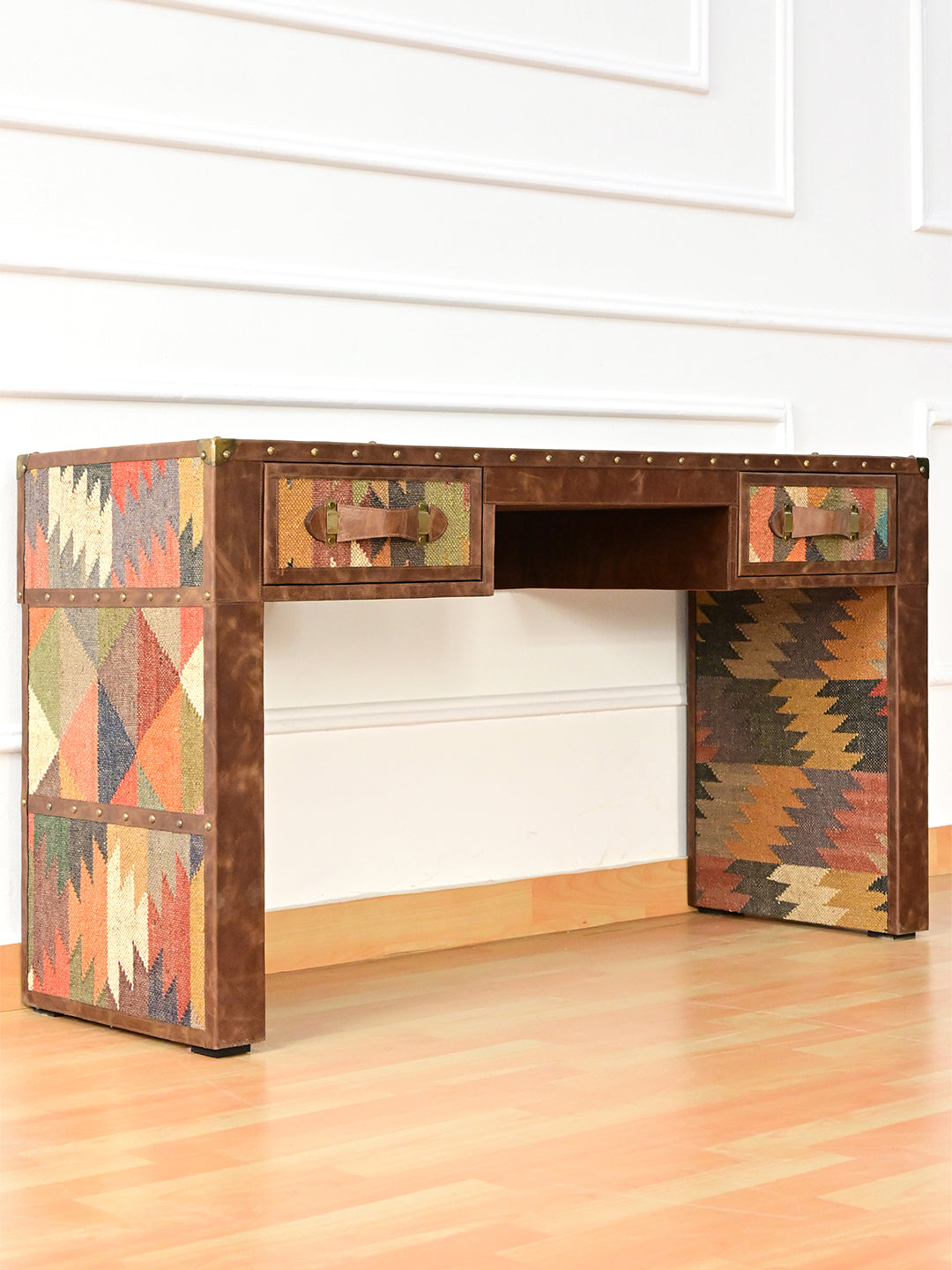 Three-quarter view of the Dungarpur desk showing the banded kilim panels on the outer leg