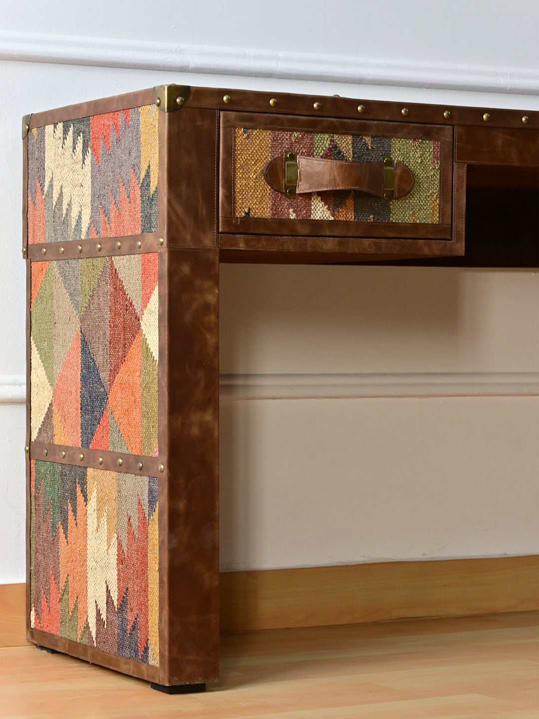 Side of the Dungarpur desk showing the kilim leg panels and brass corner cap