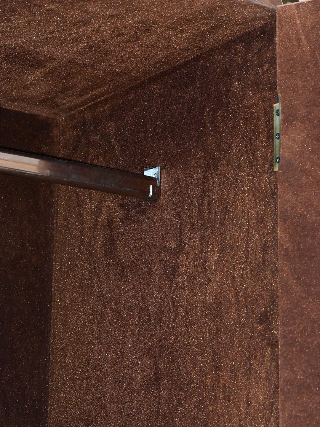 Interior detail of the suede-nap lining and hanging rail inside the Alsisar wardrobe