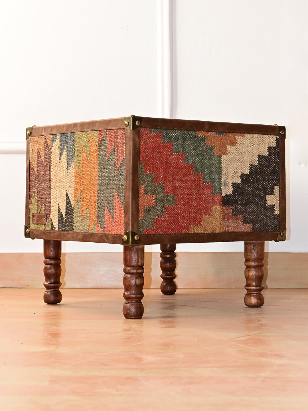 Mahansar kilim and leather bedside table, three-quarter view with kilim side and turned wood legs, Art Avenue, made to order