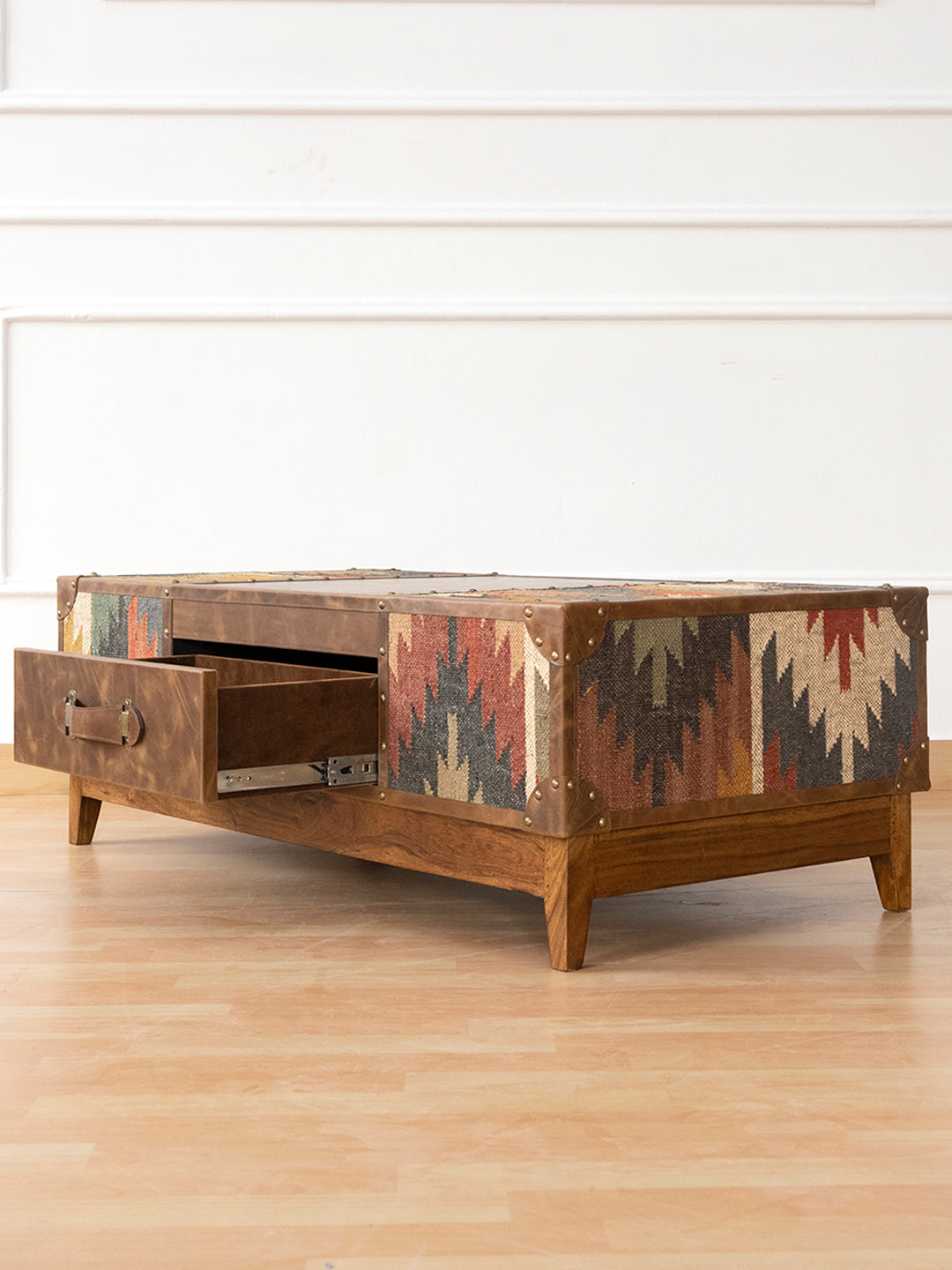 Sojat coffee table by Art Avenue, three-quarter view with drawer open and kilim-wrapped end