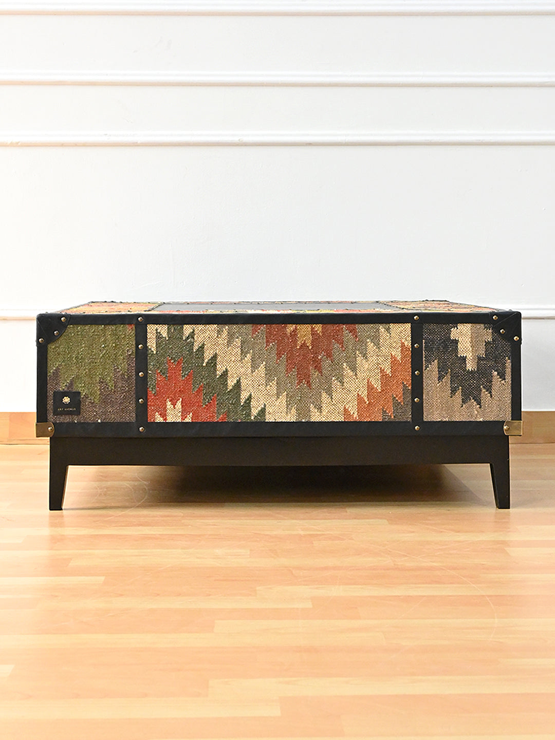 Front elevation of the Mehrangarh coffee table, three vintage kilim panels divided by studded Onyx leather straps, Art Avenue