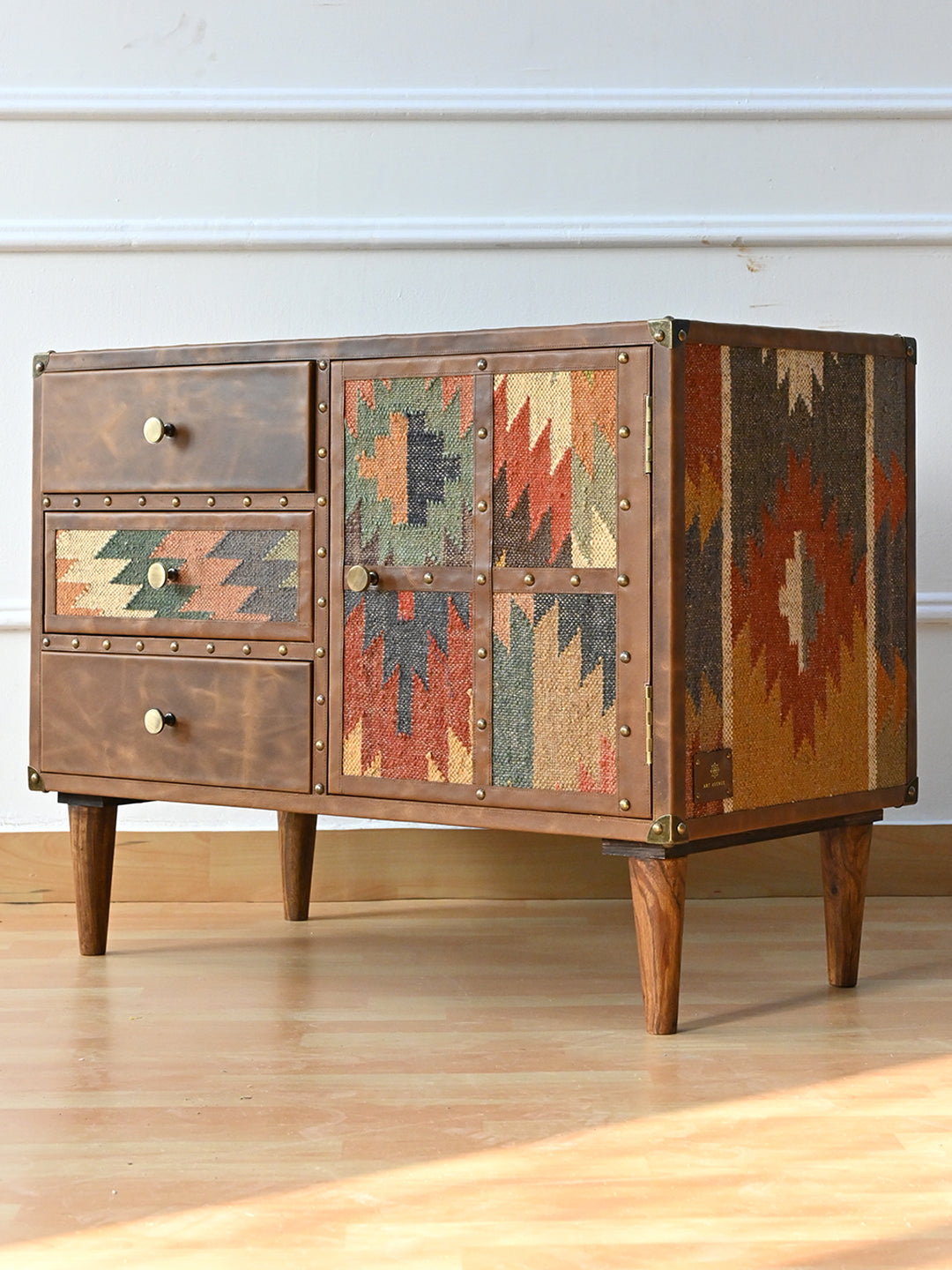 Kanota sideboard by Art Avenue in three-quarter view, showing the vintage kilim side panel and antique-brass corner caps