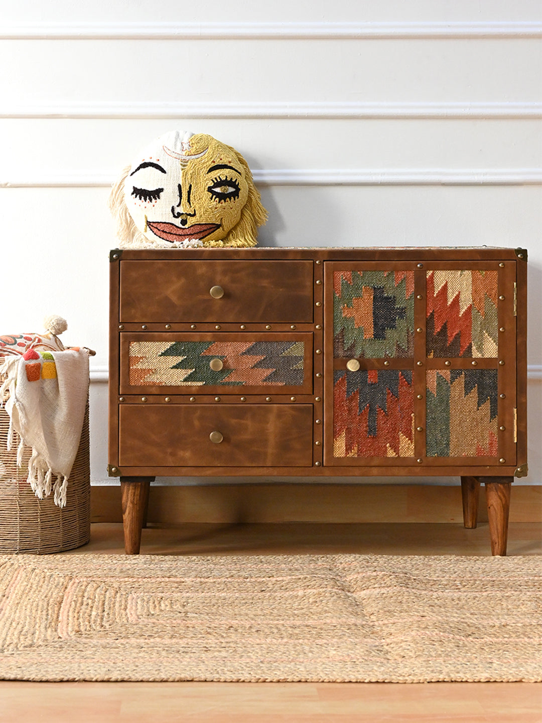 Kanota sideboard by Art Avenue styled with an embroidered face cushion, basket and jute rug