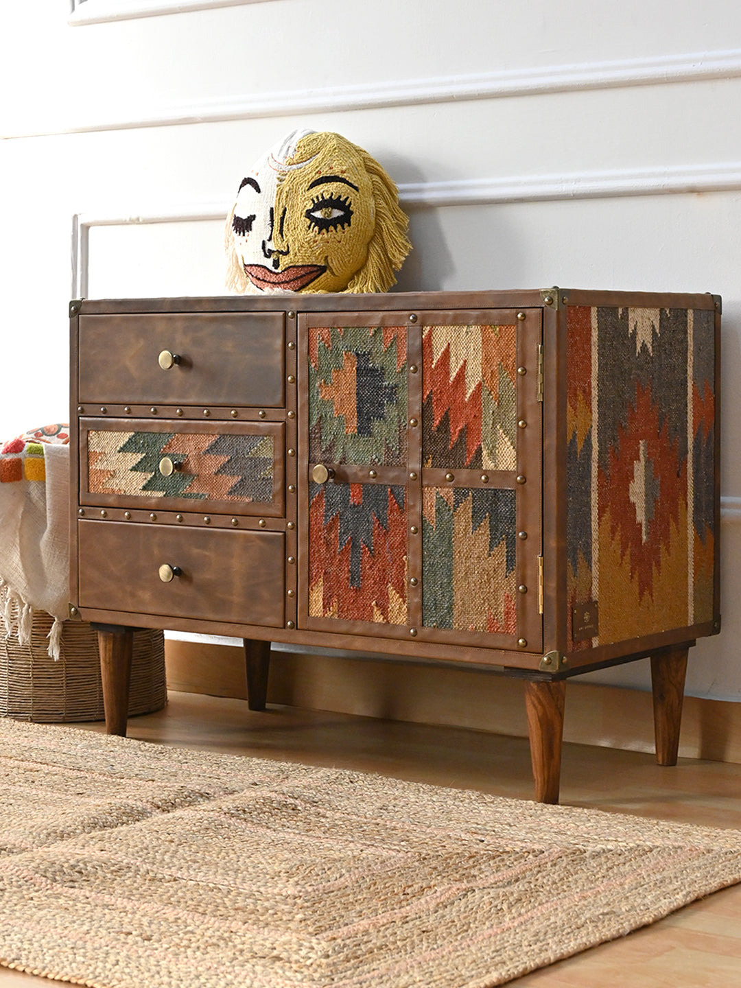 Kanota sideboard by Art Avenue styled in three-quarter view, kilim side and studded leather front visible