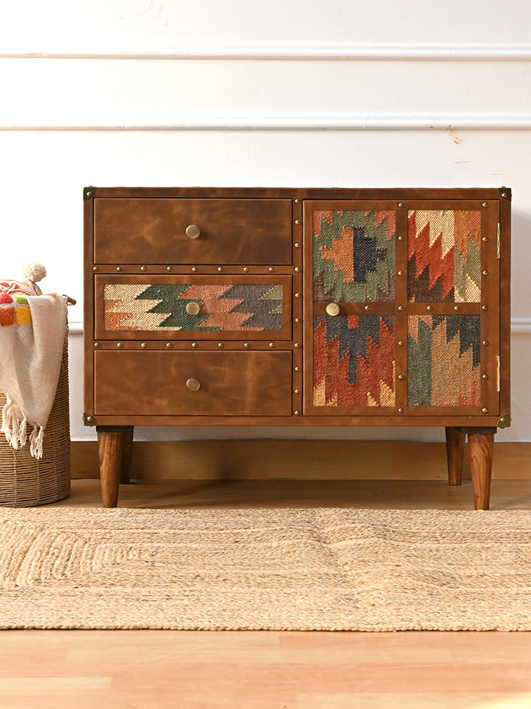 Kanota kilim and leather sideboard by Art Avenue styled front-on with a basket and jute rug