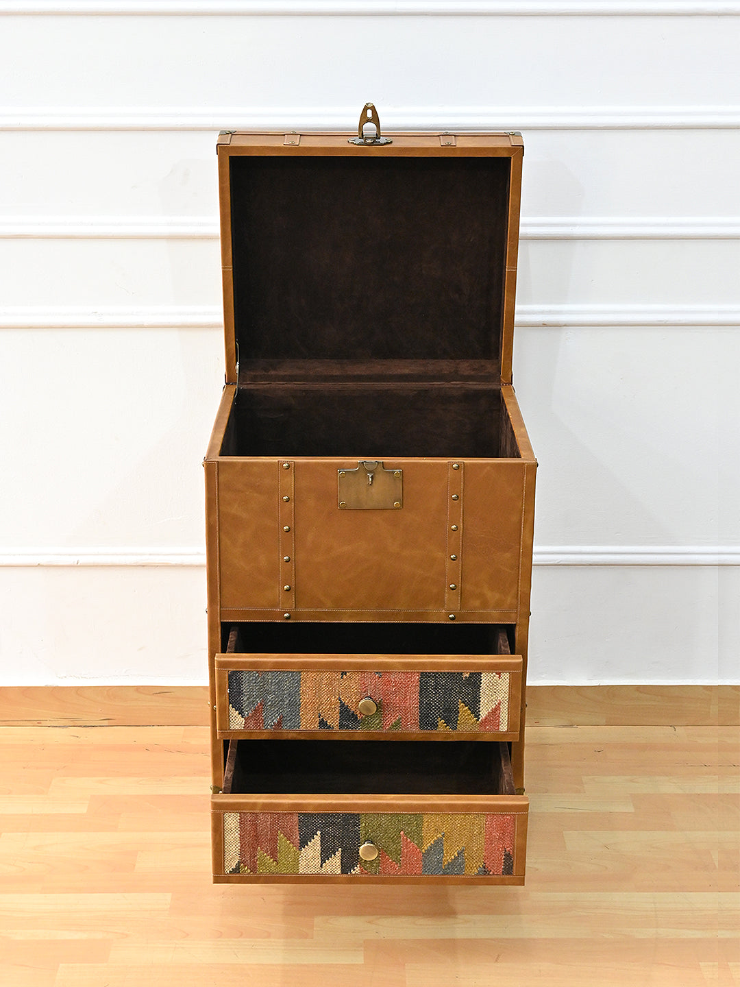 Osian trunk with the lid raised and both drawers pulled out, revealing the suede-lined interior. Art Avenue kilim and leather storage, made to order.