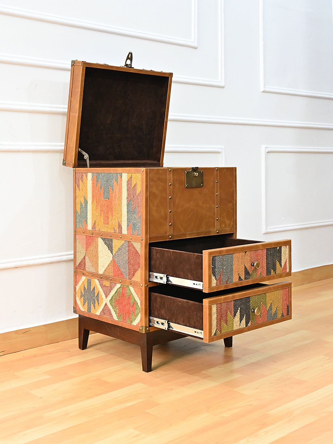 Osian trunk open at an angle — brass stay arm holding the suede-lined lid, both drawers extended on their runners. Art Avenue, made to order.