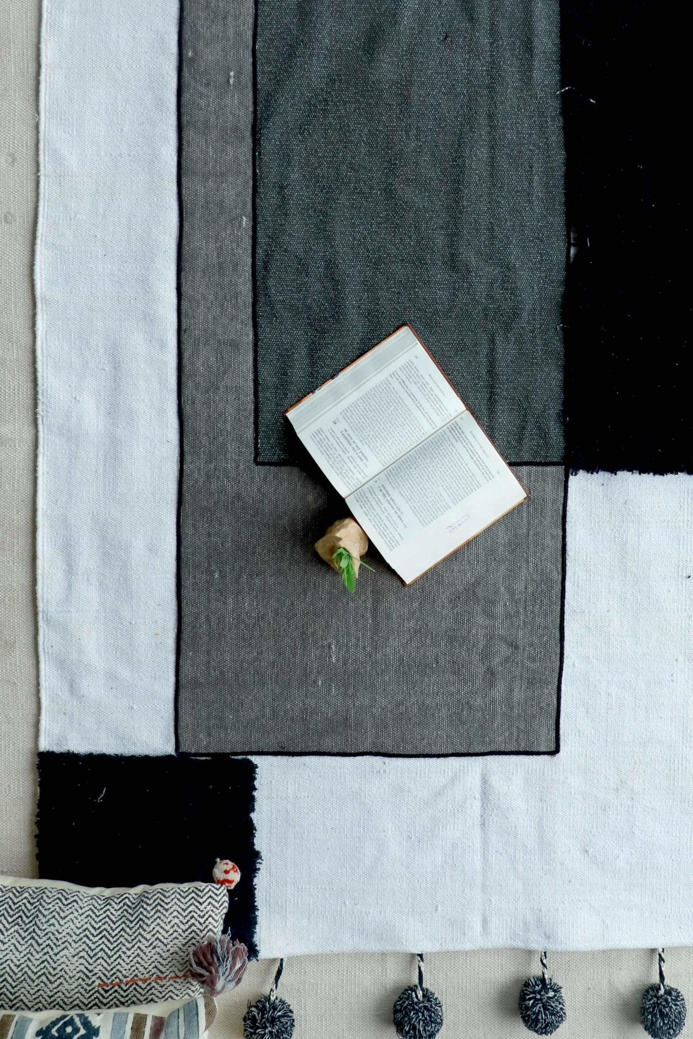 KELKI- PATCHWORK RUG WITH POM POMS - BLACK - ART AVENUE