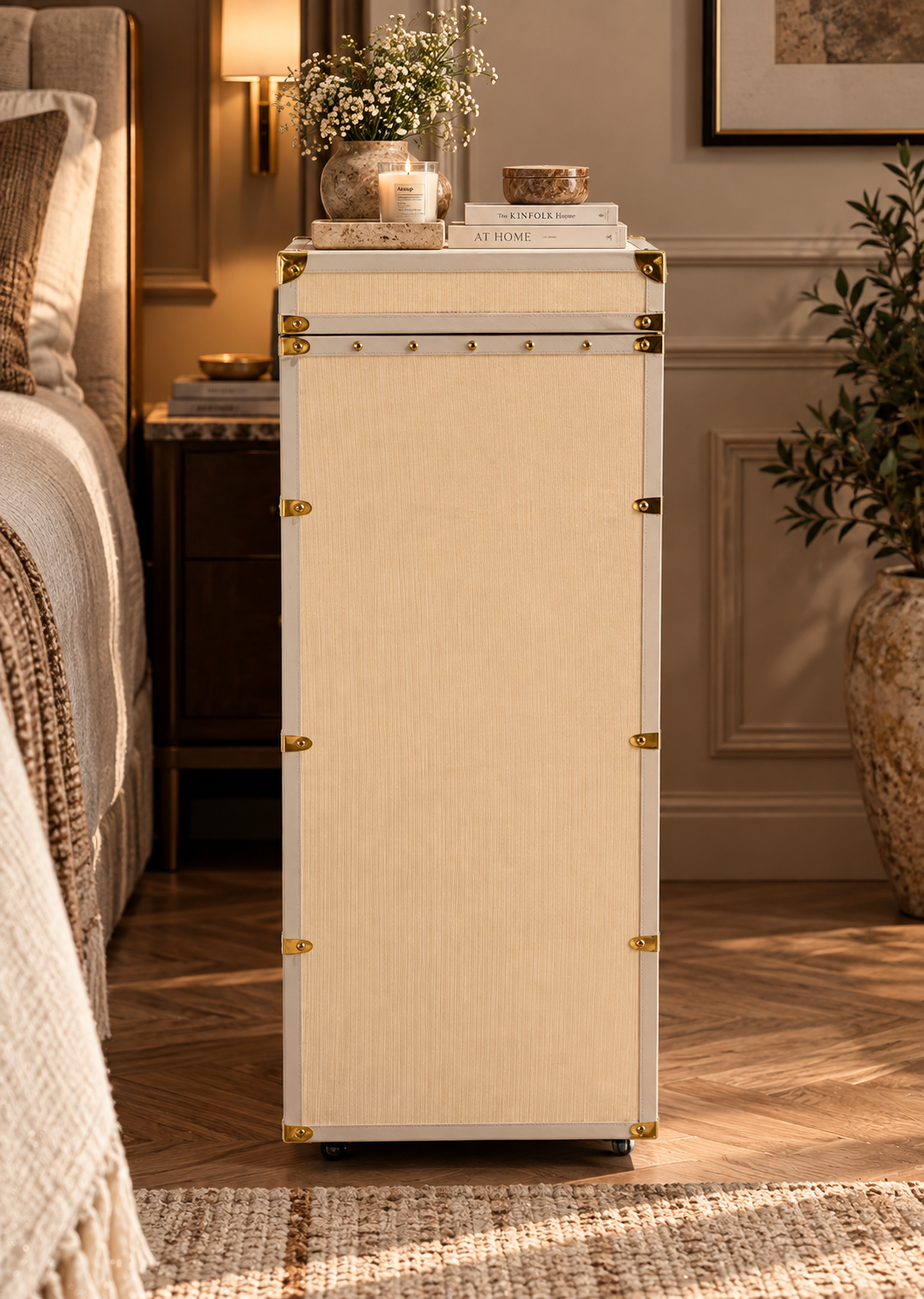 Side profile of the ivory canvas vanity trunk chest, 45 cm deep, standing on castors