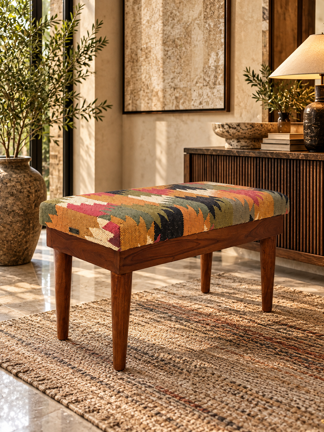 Close view of the Almora Kilim Bench showing kilim pulled taut over squared corners and the Art Avenue brand plate — Art Avenue