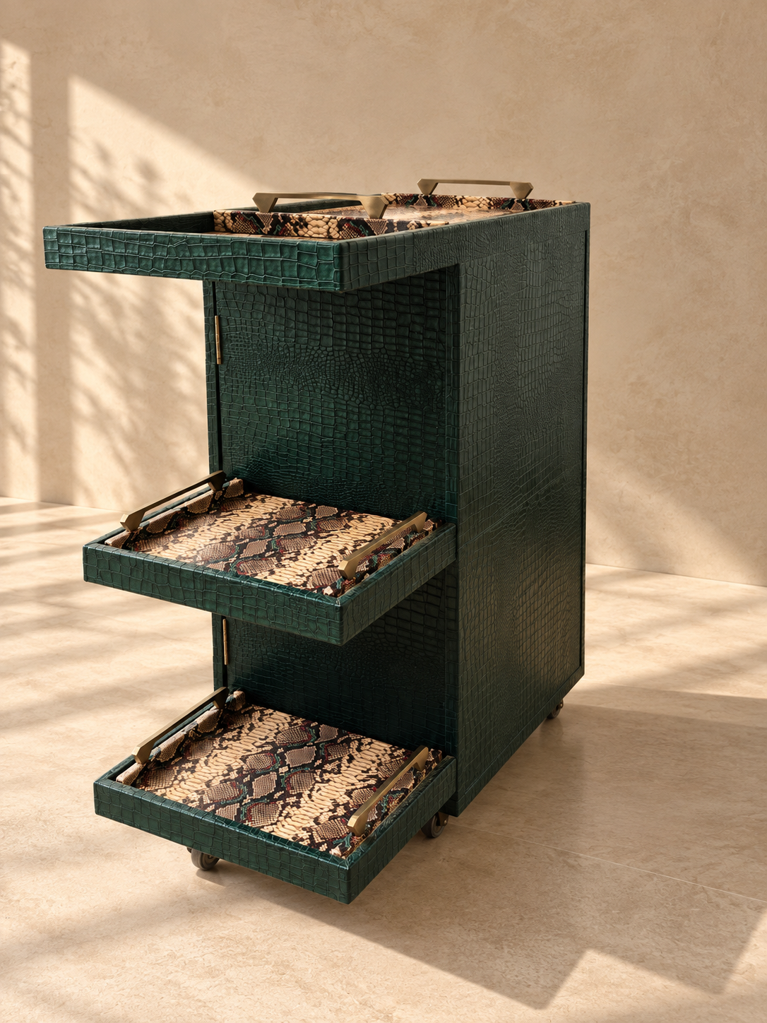 Side view of the Panjim Leather Rolling Bar Cabinet showing the two lower python-print leather serving trays with brass handles and the leather-lined top tray — Art Avenue, made to order