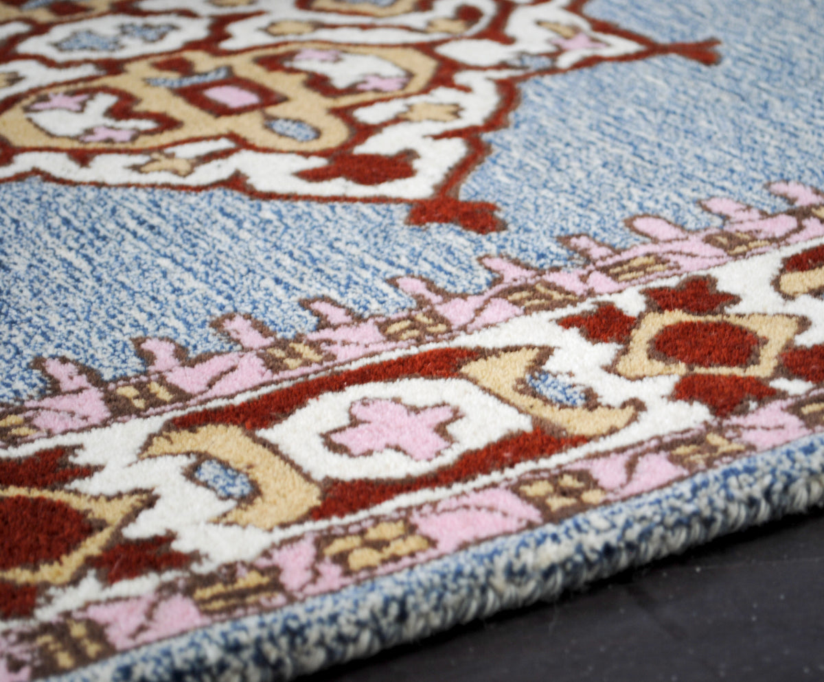 Close-up of the Lucknow rug's wide ivory border with burgundy cartouches and rose-pink crosses, hand-tufted New Zealand wool, Art Avenue