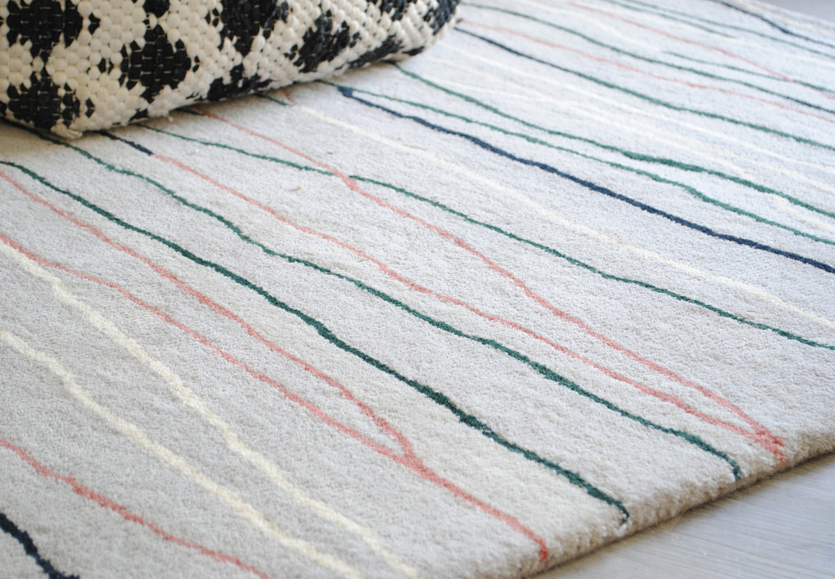 Chilika hand-tufted rug, angled view of the loose drawn lines running to the edge with no border