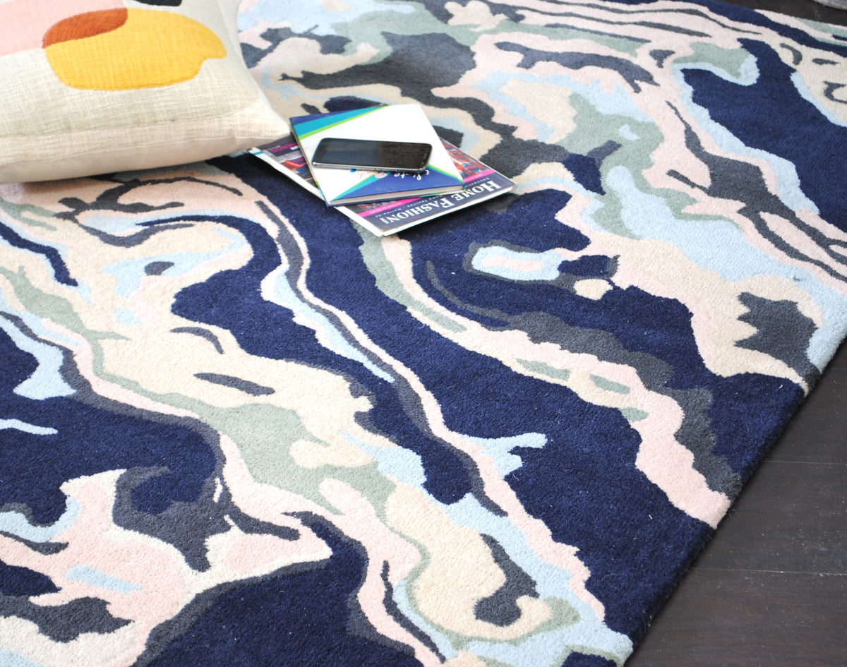 Makrana hand-tufted wool rug with marbled navy, blush and sky blue bands