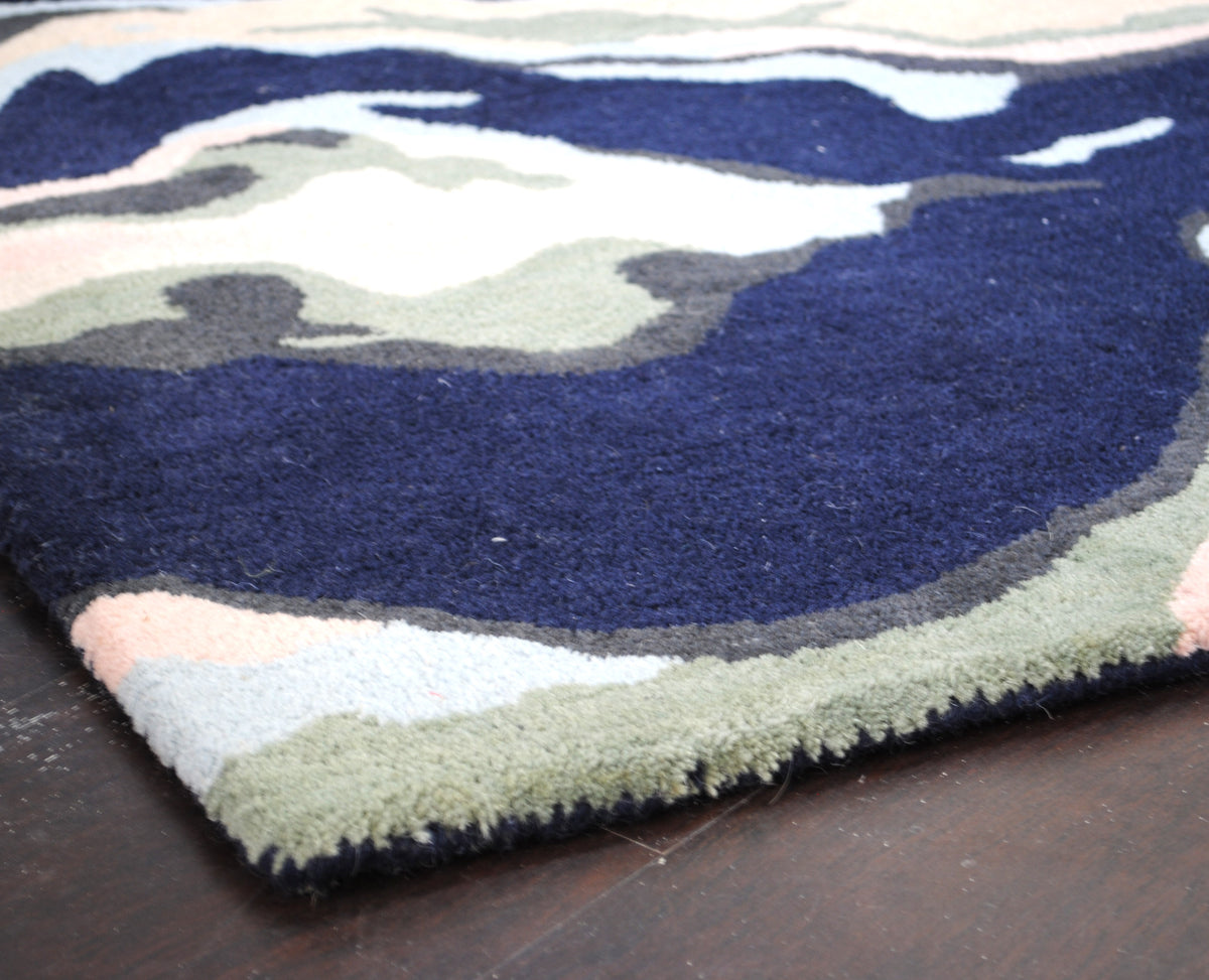 Makrana hand-tufted wool rug with marbled navy, blush and sky blue bands