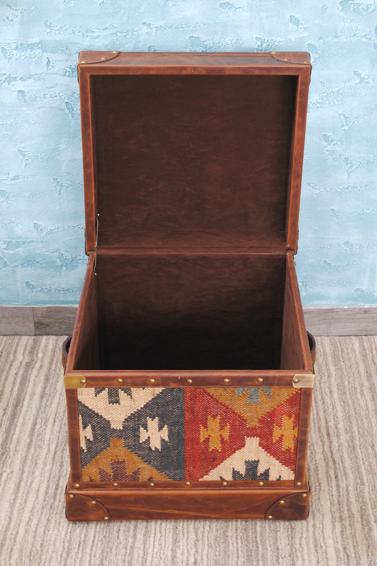 Madras kilim trunk open, showing the deep suede-lined well and suede-lined lid